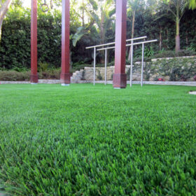 a grass field with metal poles
