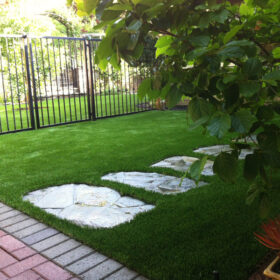 a stone path in a grassy area