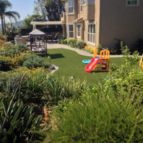 a backyard with a playground and a house