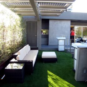 a patio area with a white couch and a table
