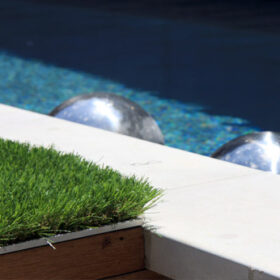 a pool with a grass patch