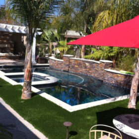 a pool with a red umbrella